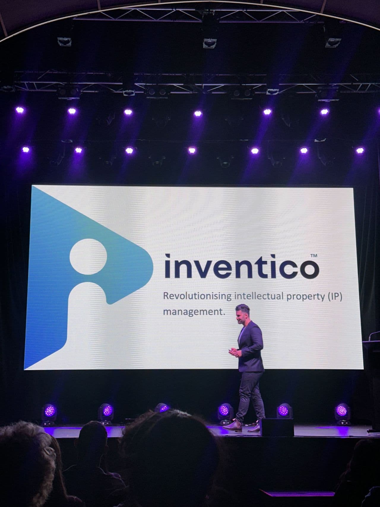 Inventico presenting on stage to a Brisbane audience